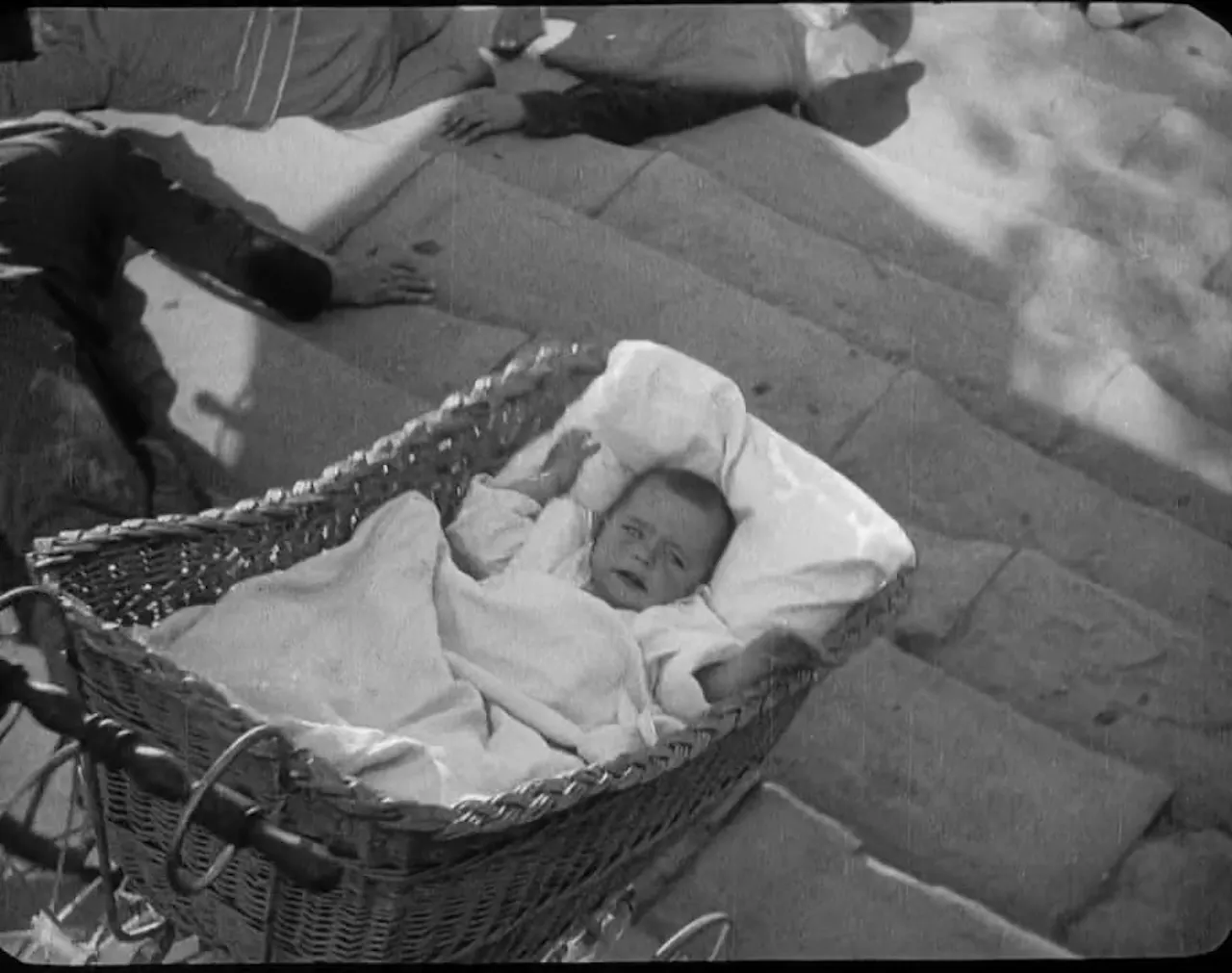 The baby carriage on the Odessa Steps in Battleship Potemkin (1925). Frame from the film, public domain, via Wikimedia Commons.