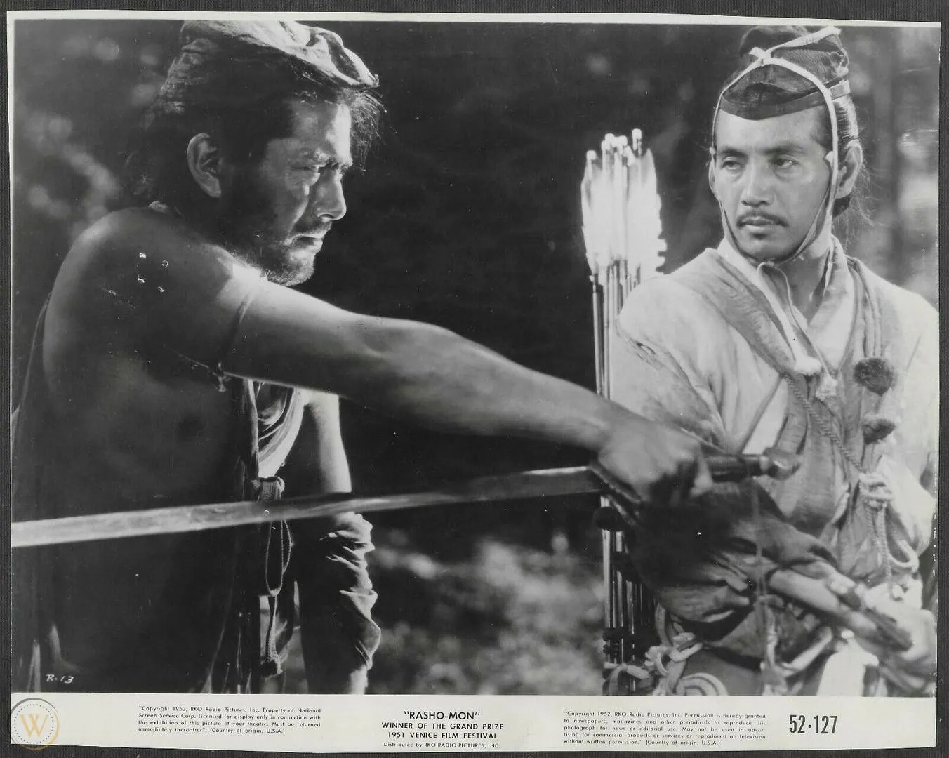 Toshiro Mifune as the bandit Tajōmaru and Masayuki Mori as the samurai in Rashomon (1950). Daiei press photo, public domain, via Wikimedia Commons.