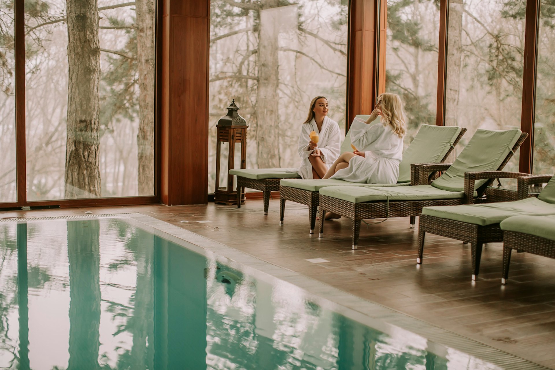 Women relaxing on the deckchair by the swimming pool