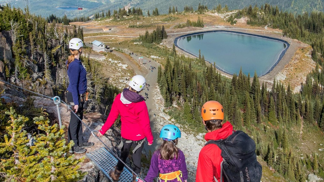 Group of hikers gazing at the lake at Whistler Blackcomb in British Columbia, Canada.