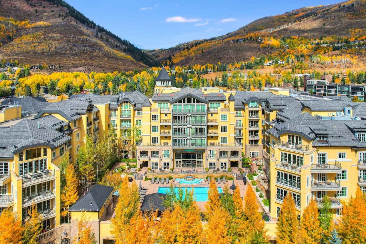 The resort at Breckenridge is nestled among lush trees and majestic mountains, showcasing a serene natural landscape.