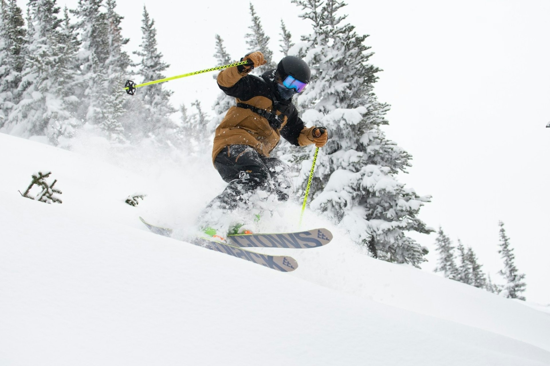 Male skier in ugly mustard colored ski jacket hitting the slopes at Whistler Blackcomb in British Columbia, Canada.