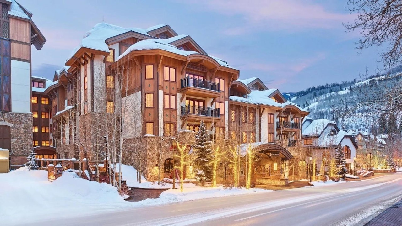The St. Regis Aspen, a prestigious resort nestled in the mountains, featuring a grand facade and scenic winter landscape.