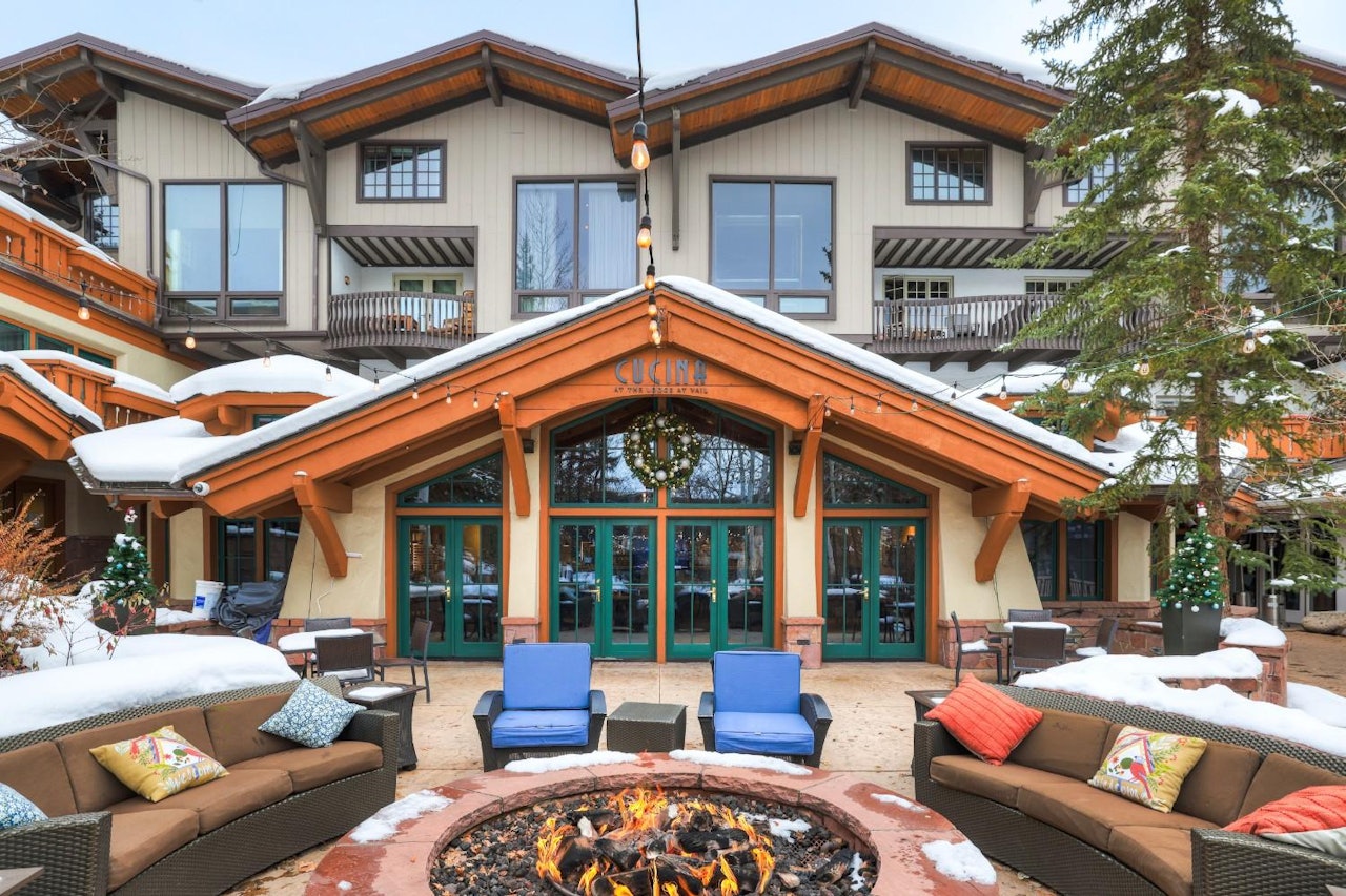 The lodge at Breckenridge Resort, featuring rustic architecture and surrounded by snow-capped mountains.