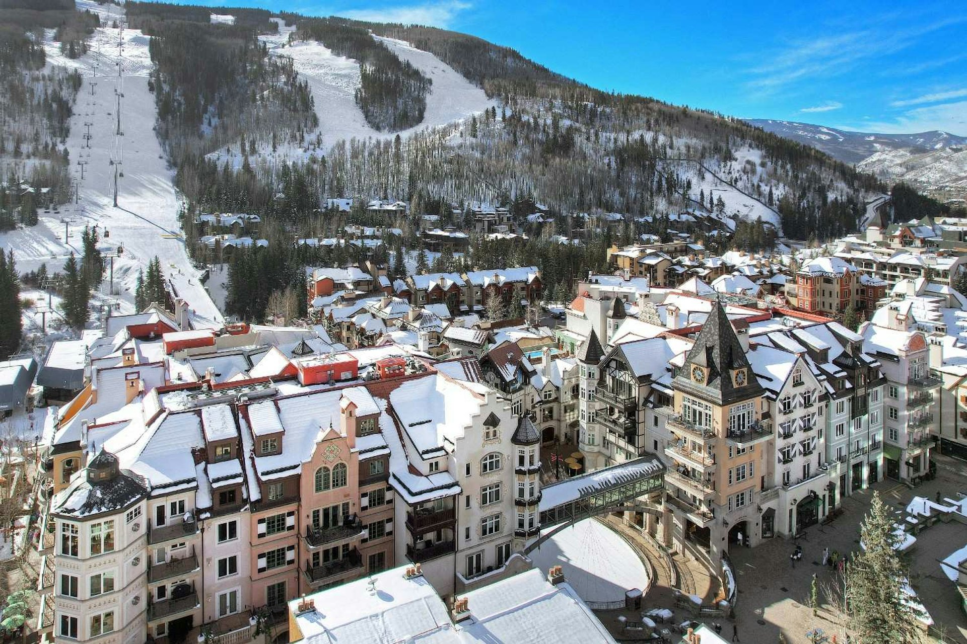 Overhead perspective of a ski resort, highlighting ski trails, lodges, and the winter landscape.