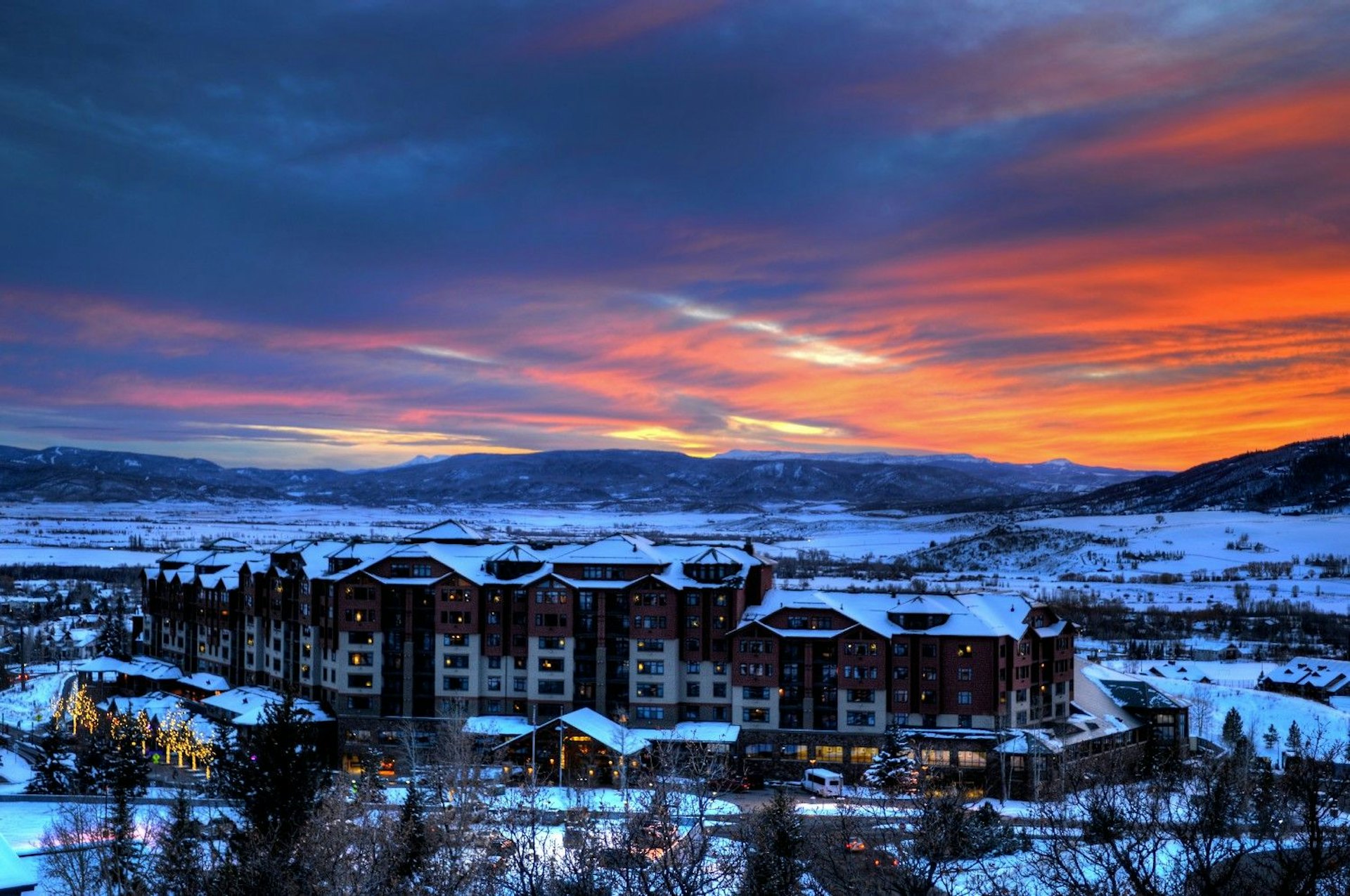 The St. Regis hotel in Boulder, Colorado, showcasing its elegant architecture against a scenic mountain backdrop.