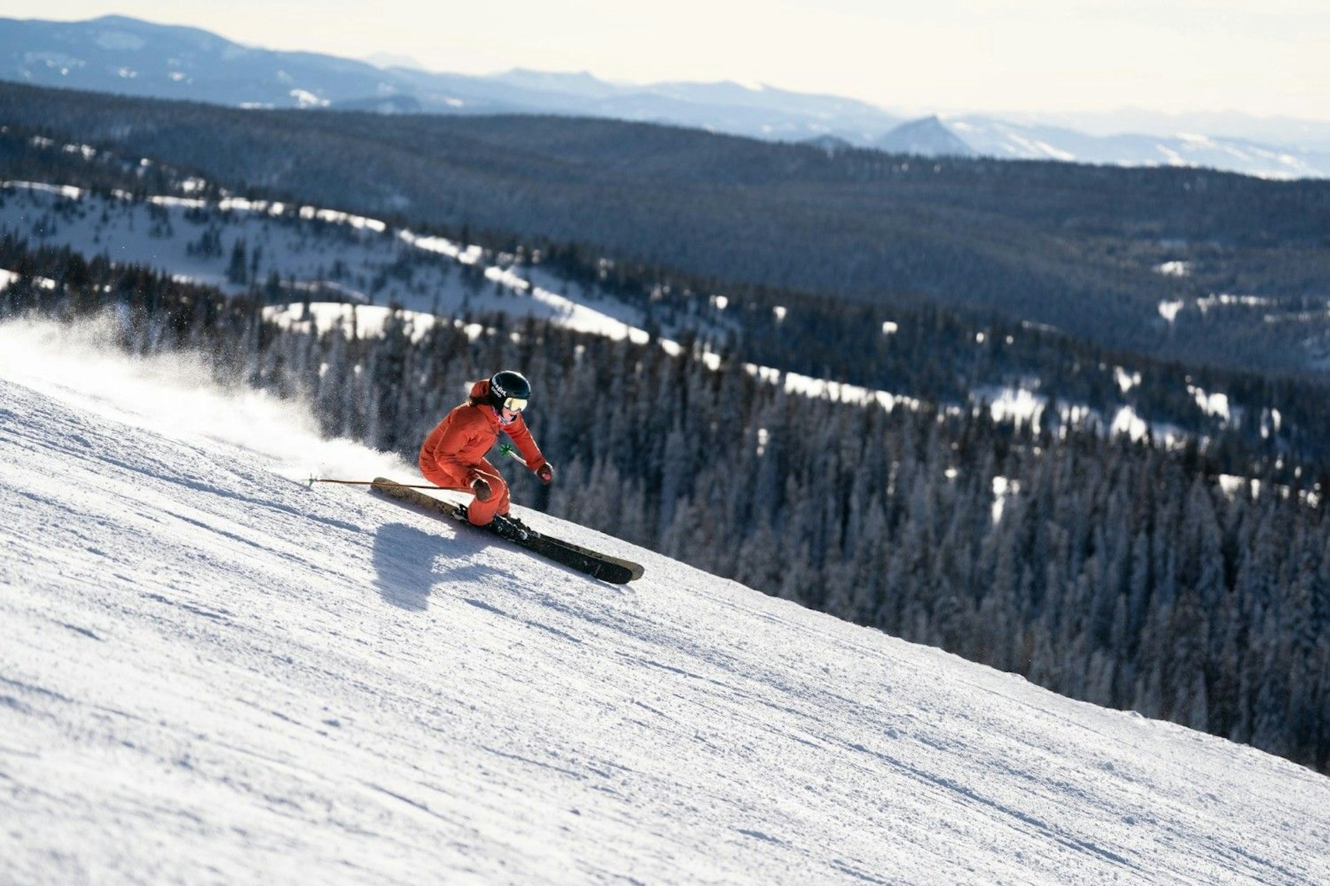 A person snowboarding down a snowy slope, showcasing dynamic movement and winter sports excitement.