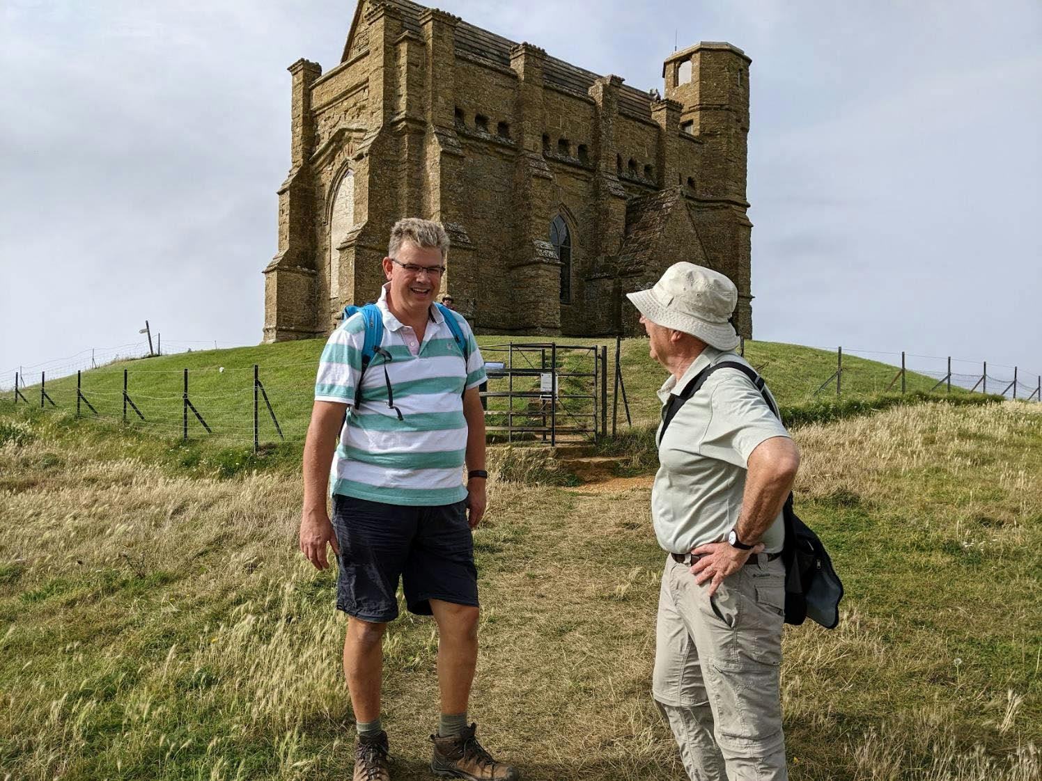 Two men on a hill near Abbotsbury, with a chapel behind them