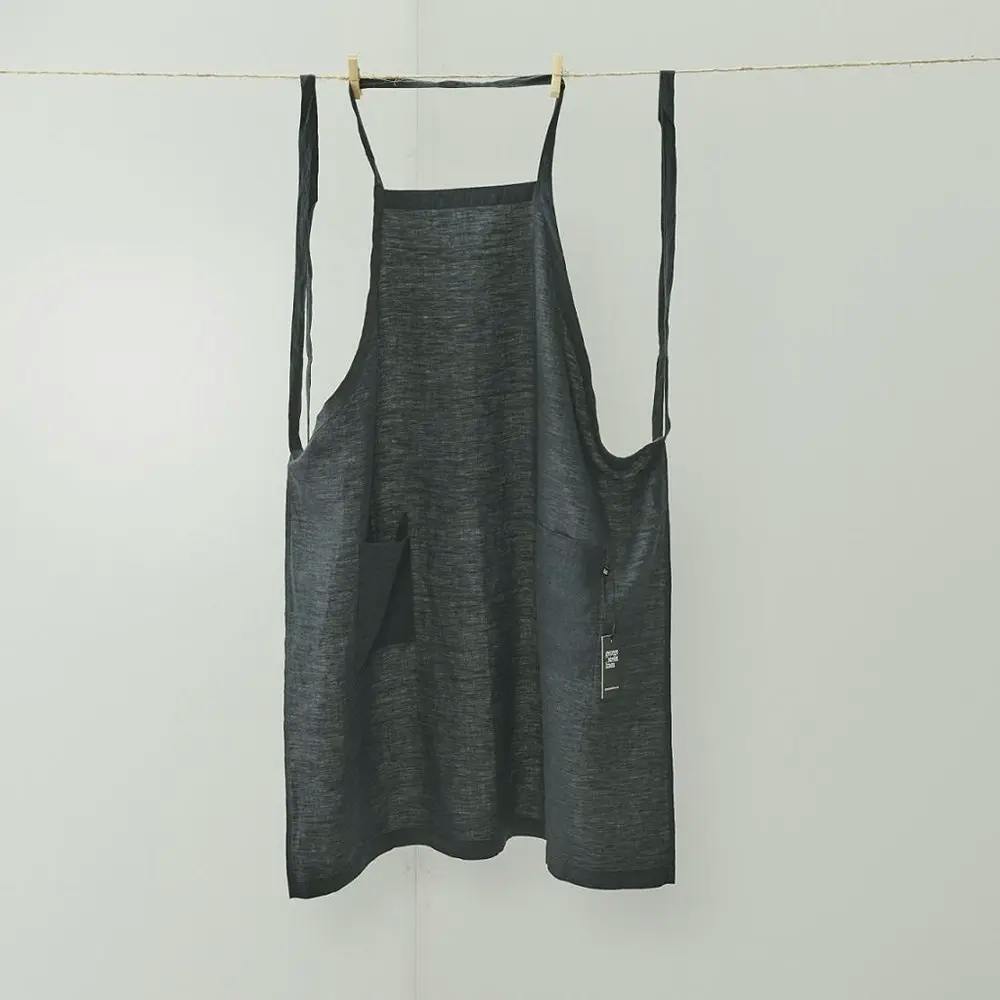 black linen apron hanging on line