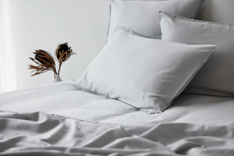 Soft washed cotton bedding in frost grey with matching pillowcases on a neatly styled bed