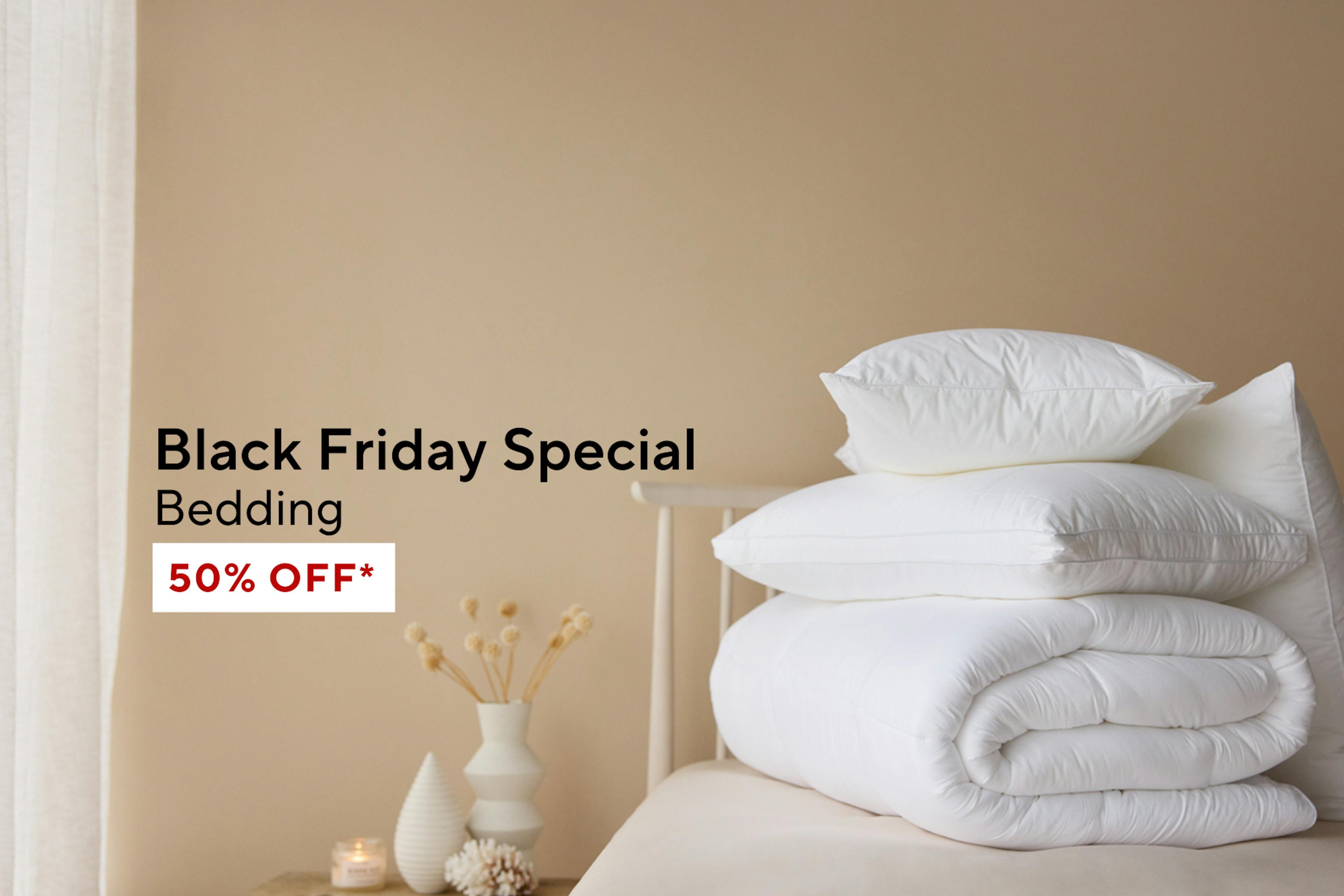 White bedding set stacked on a bed with text overlay reading 'Black Friday Special – Bedding, 50% OFF*'. Shop Now Button below