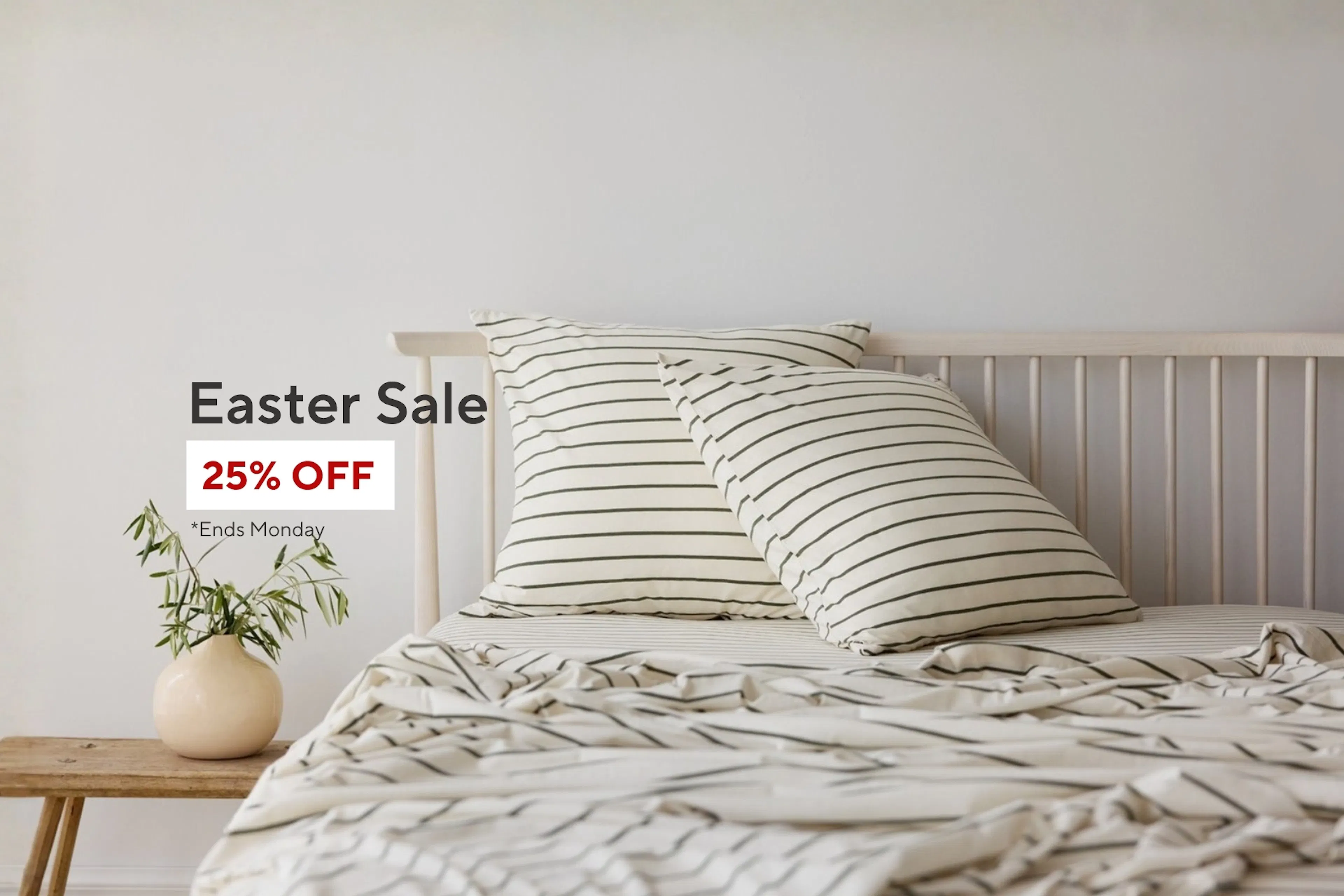 Easter sale banner showing a neatly styled bed with neutral striped linen bedding, wooden headboard, and a small bedside table with a vase. Text reads “Easter Sale – 25% OFF, ends Monday.