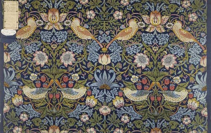  Furnishing fabric on block-printed cotton. The image has repeated birds, strawberries and flowers. The pattern is in brown, yellow and shades of green, blue and red on a dark blue ground.