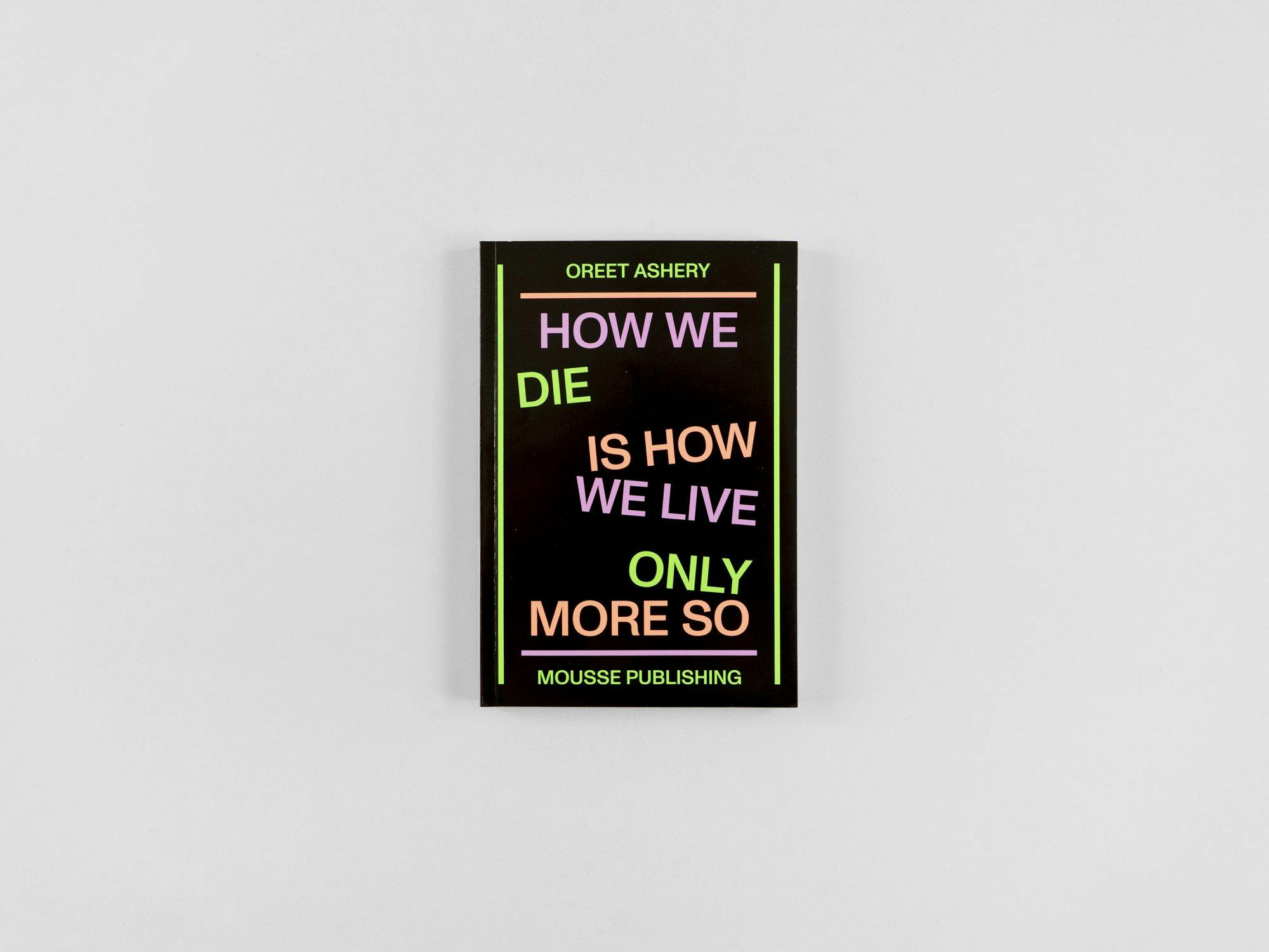 A picture of a book in black with bright typography that says "who we die is how we live only more so."  