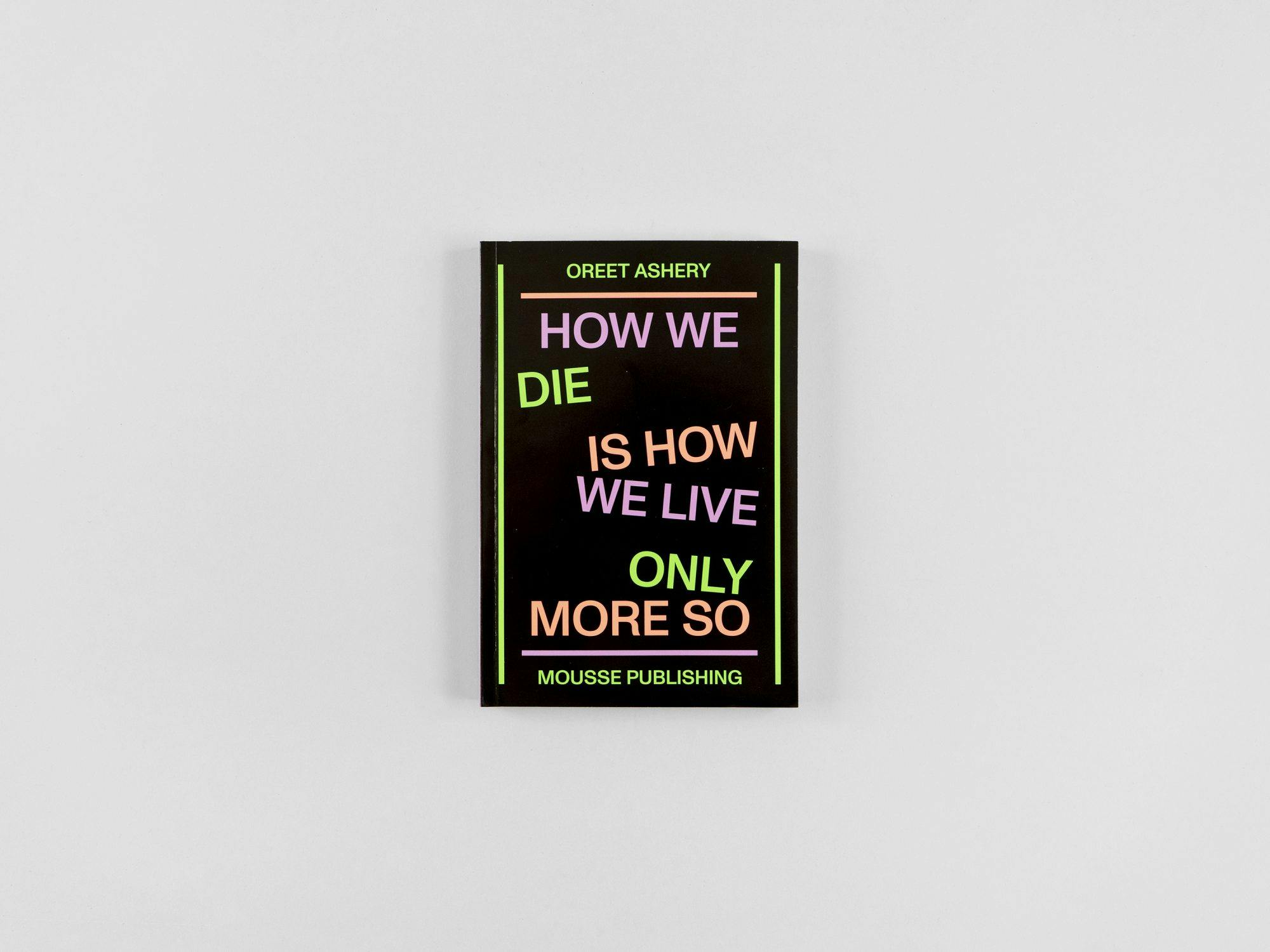 A picture of a book in black with bright typography that says "who we die is how we live only more so."
