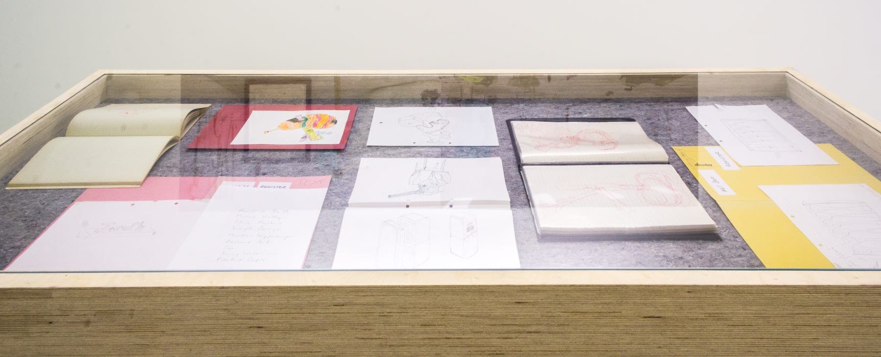 A vitrine with notebooks and sketches of ideas for works. 