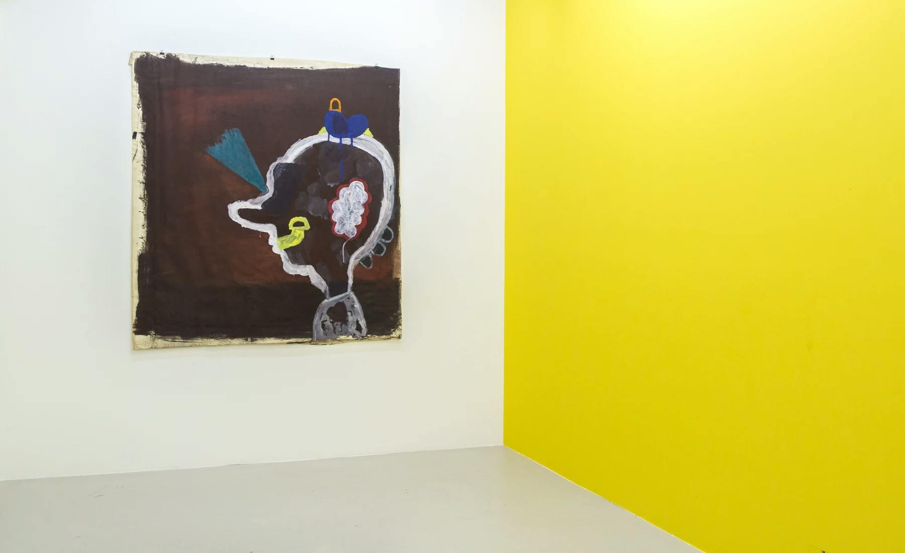 A large painting of a cartoon like head with big nose and various colourful and abstract shapes adorning it.