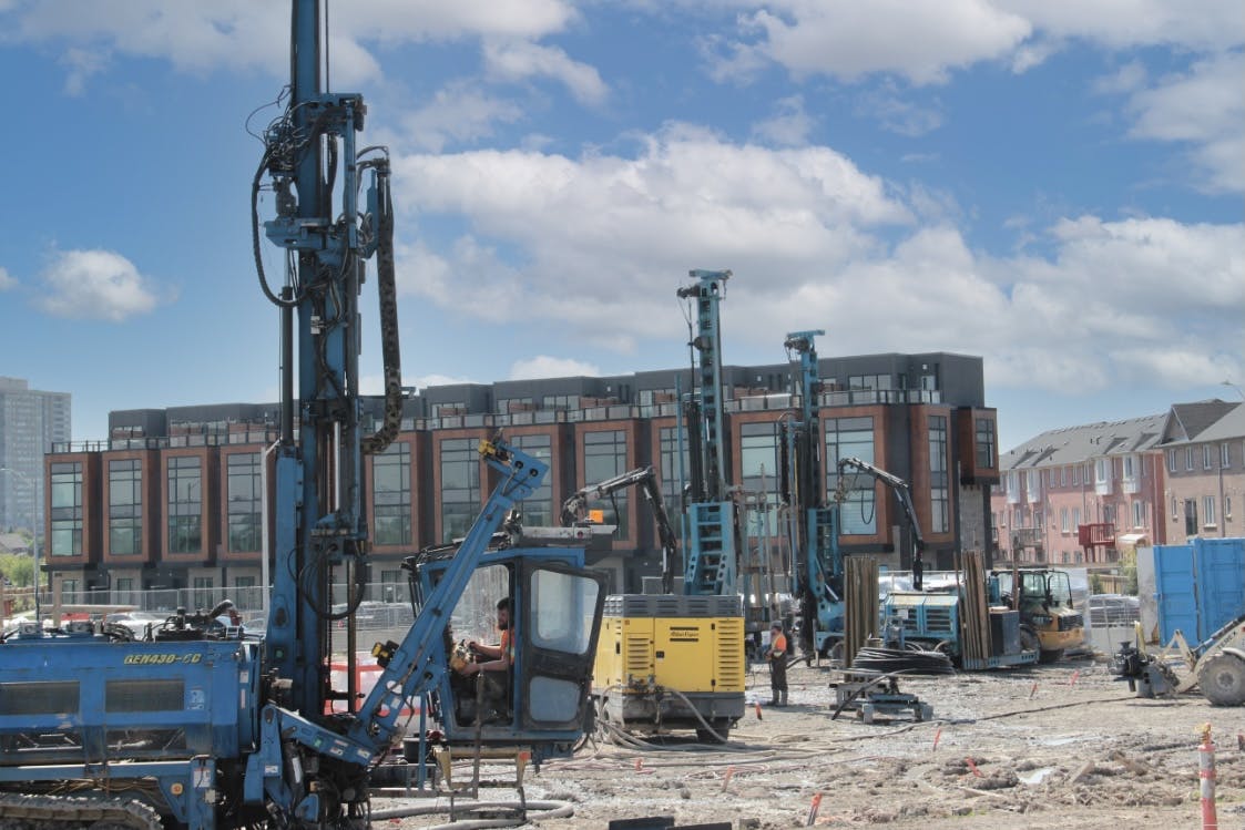 Three large machines drilling into the earth