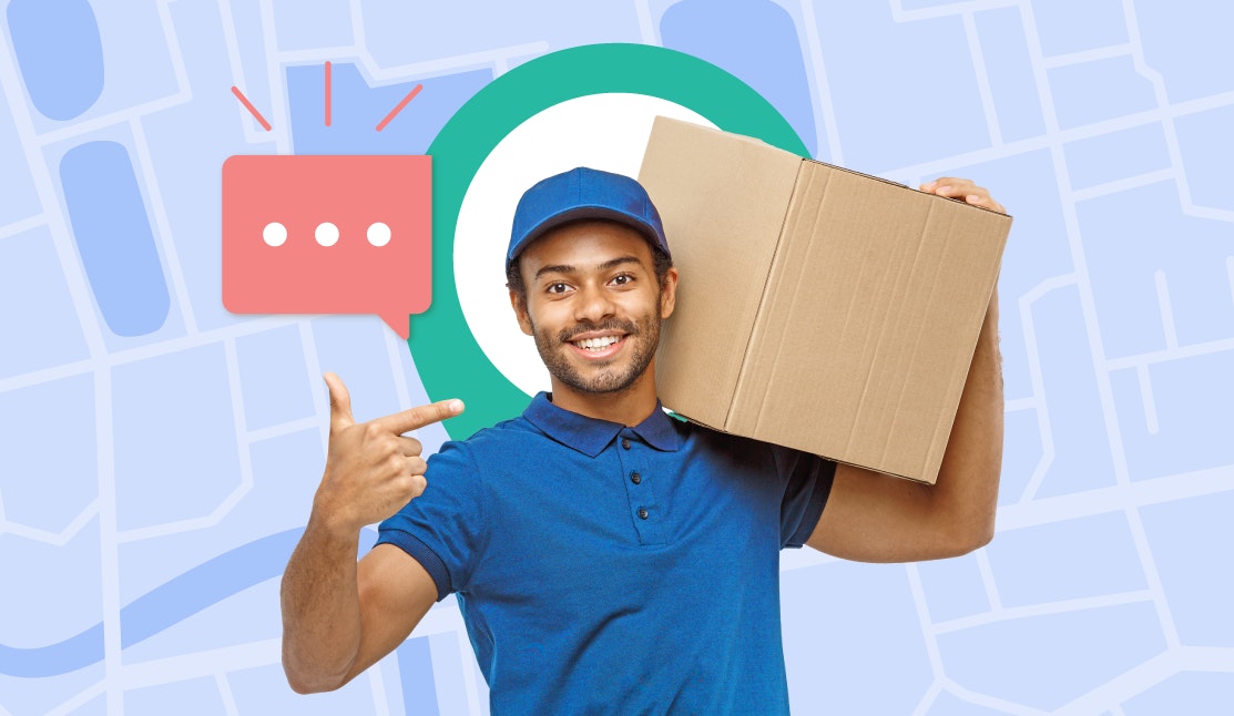 Male delivery driver carrying and pointing at a large cardboard box on his shoulder.