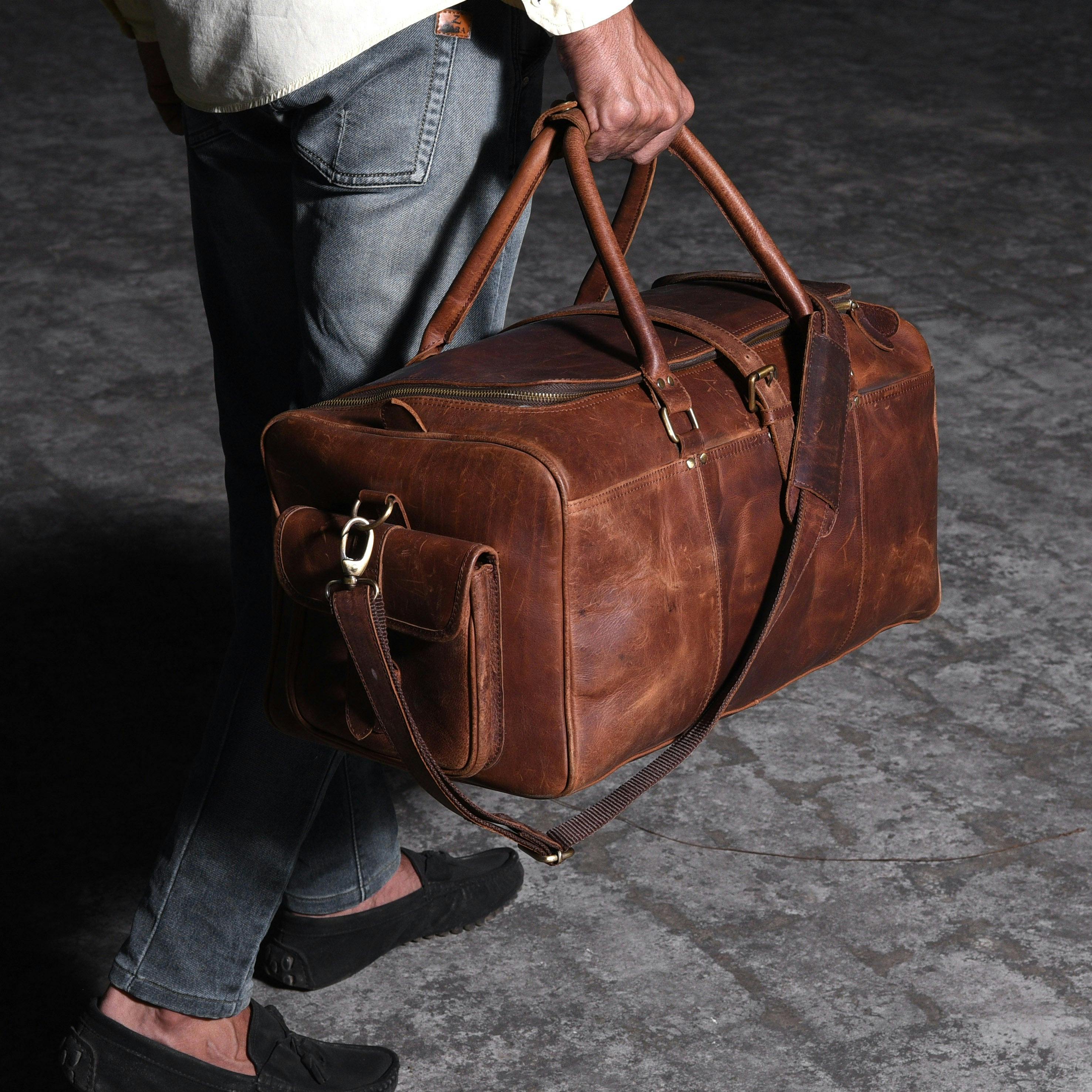 Man walking with a leather travel bag