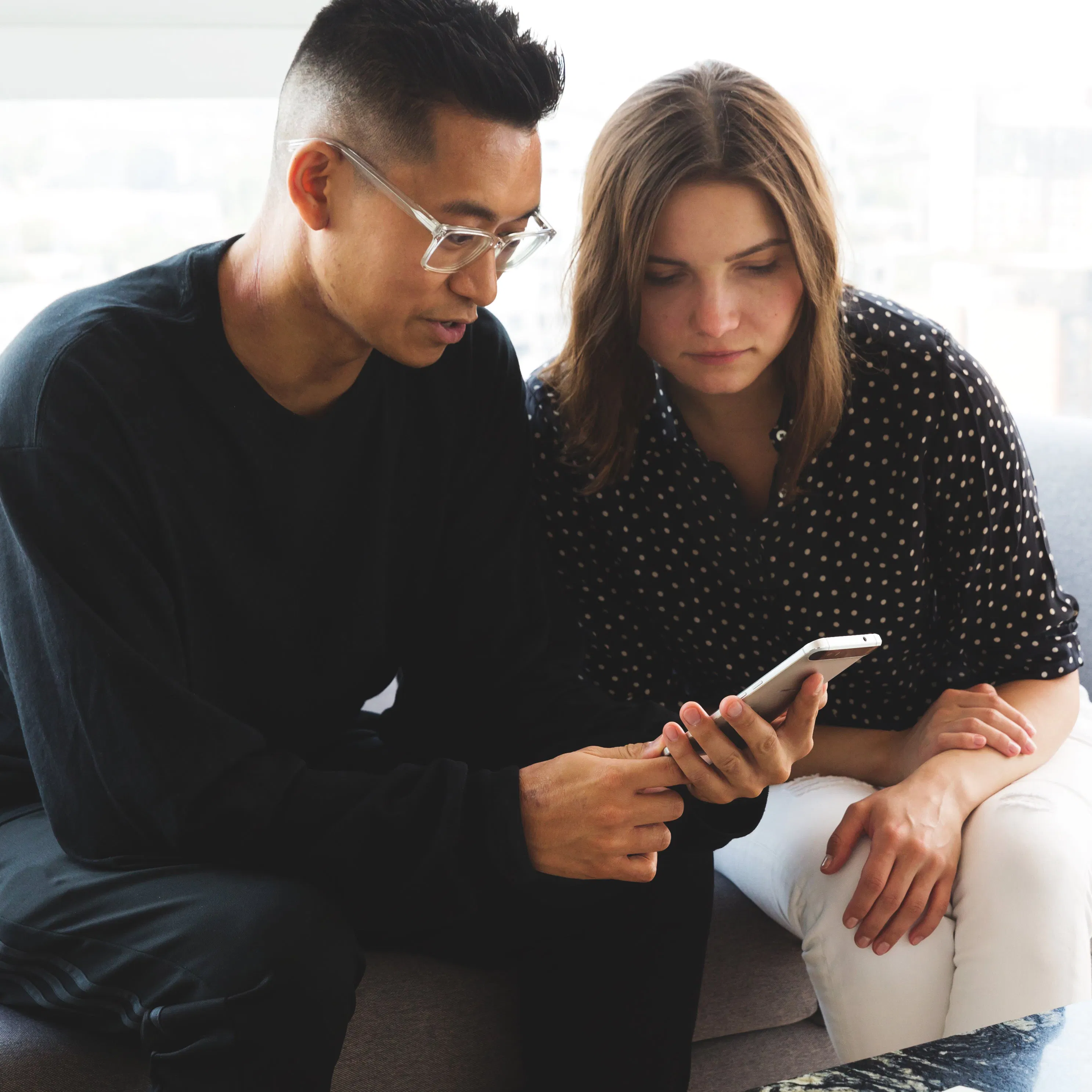Man and woman looking at phone