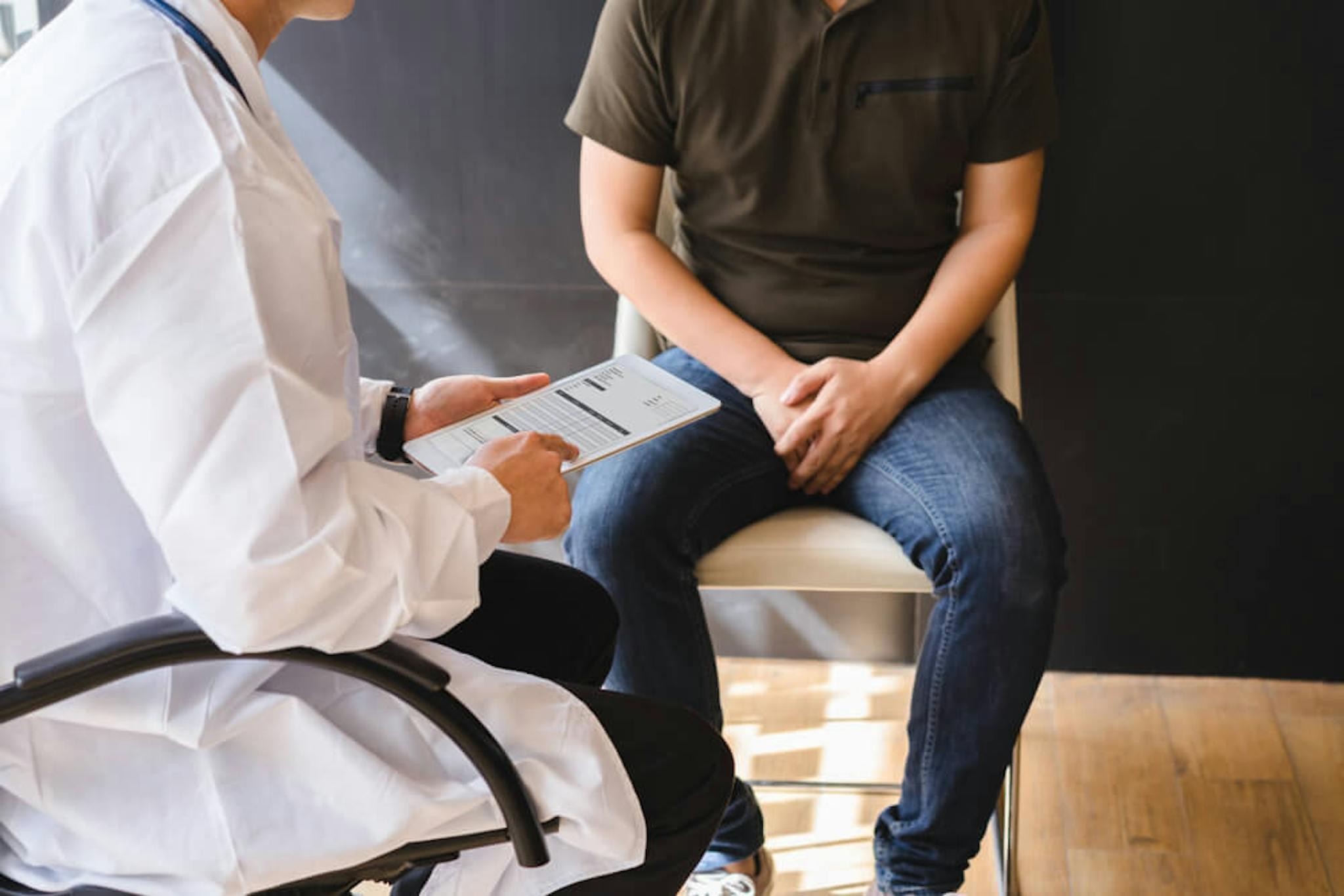 male discussing problem with his doctor