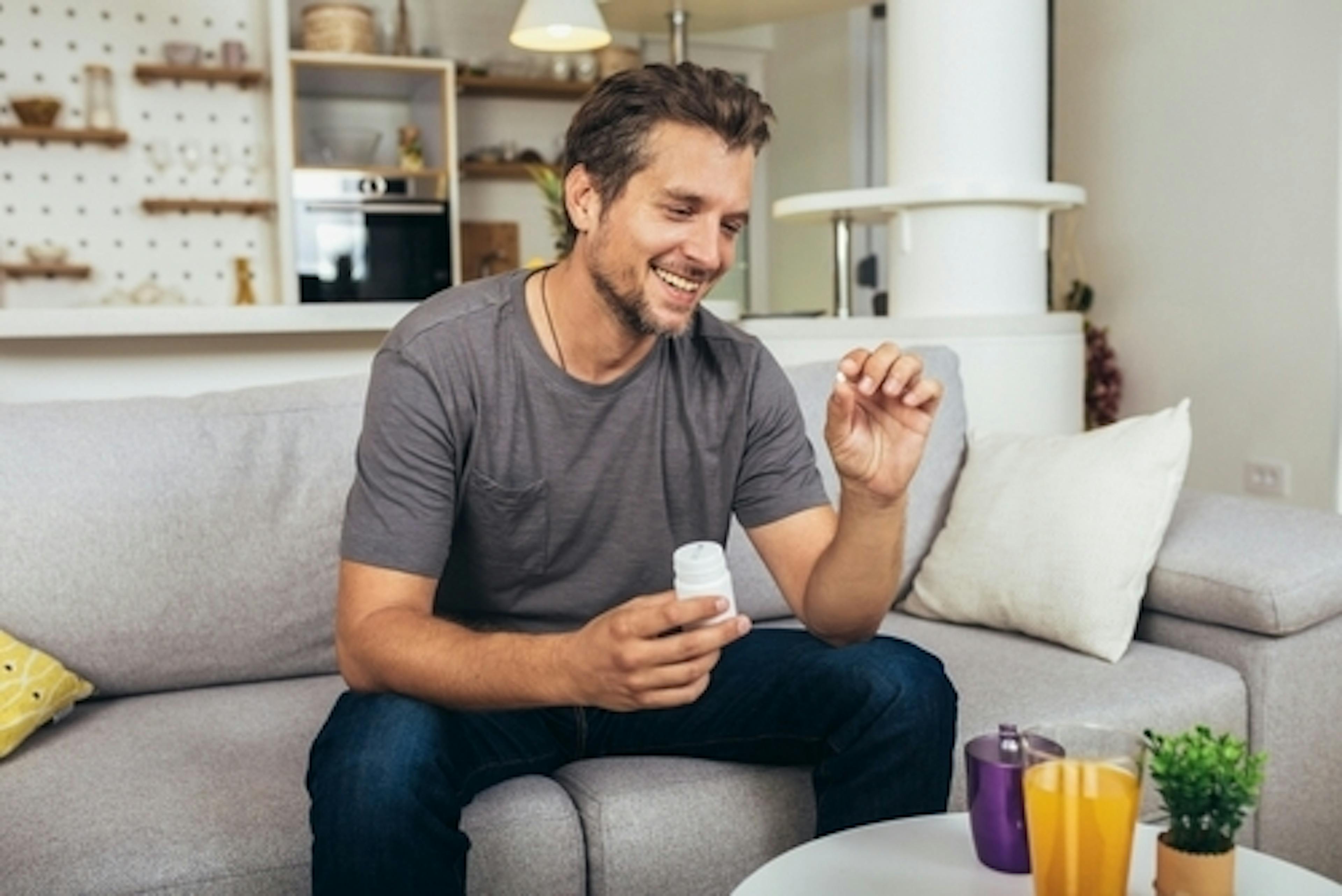 man sitting having his pills