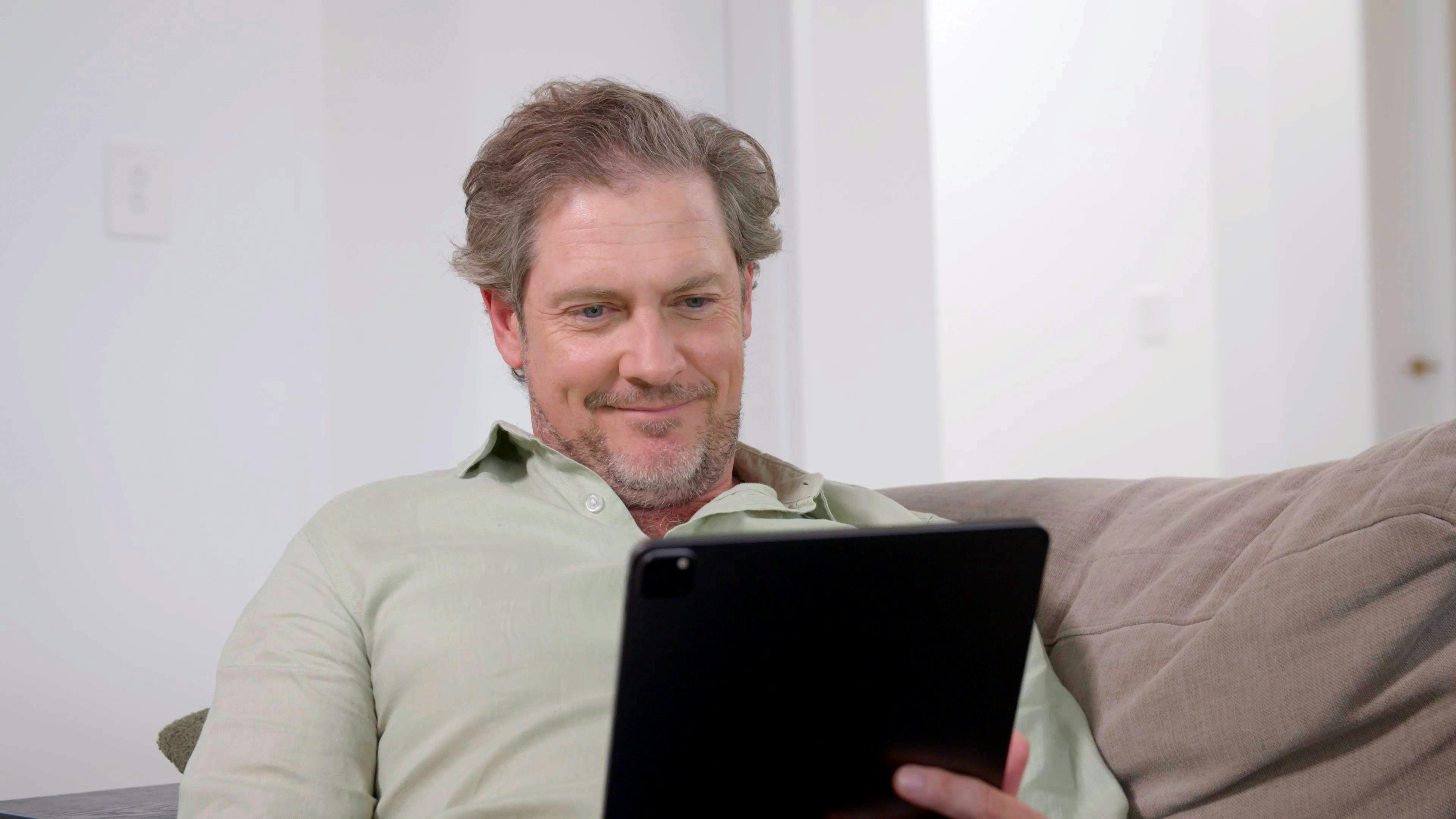 man booking a consult on ipad