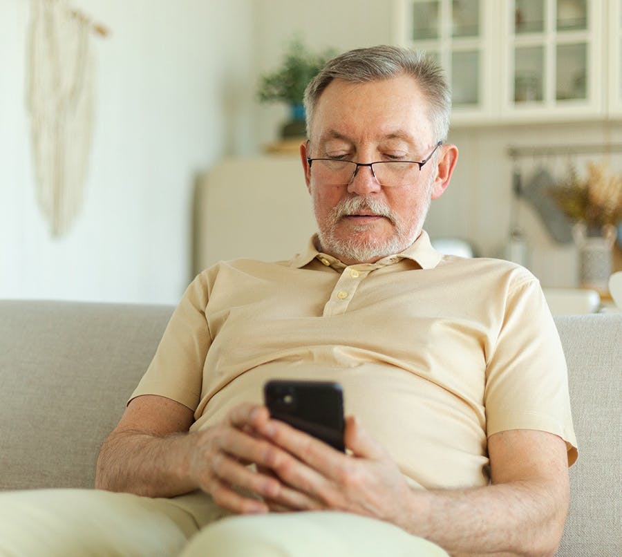 An old man looking at his phone