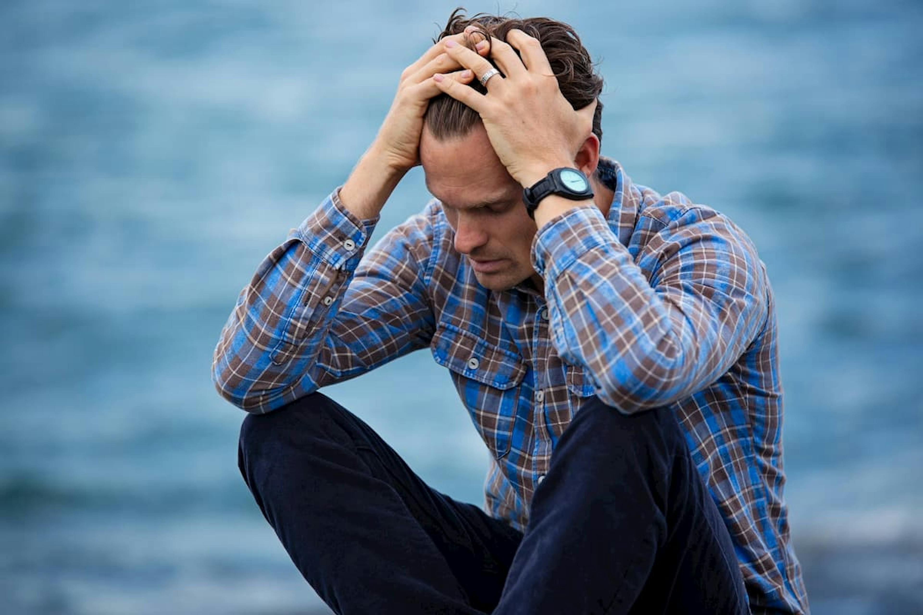 Stressed man holding his hair