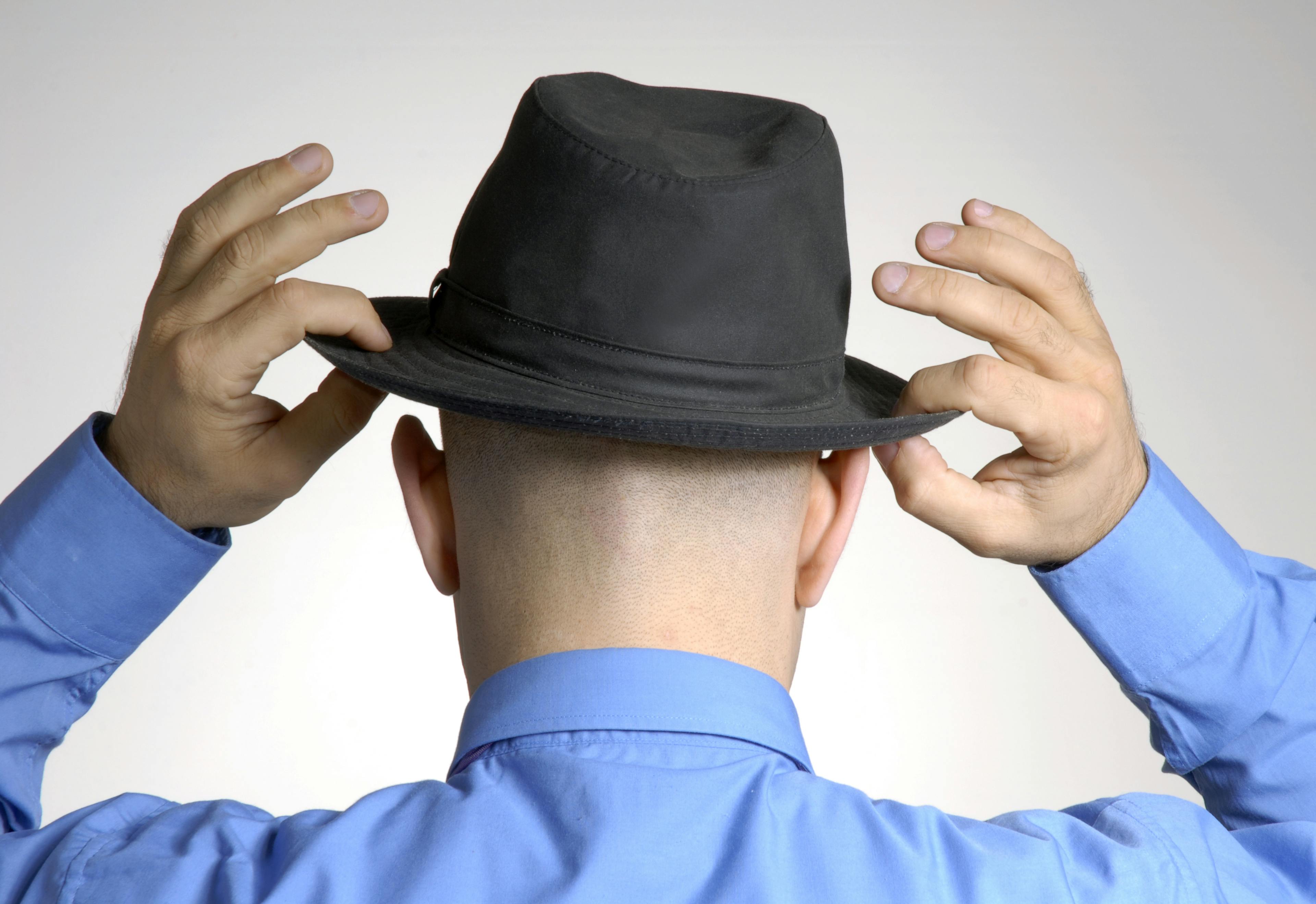 bald man wearing a hat