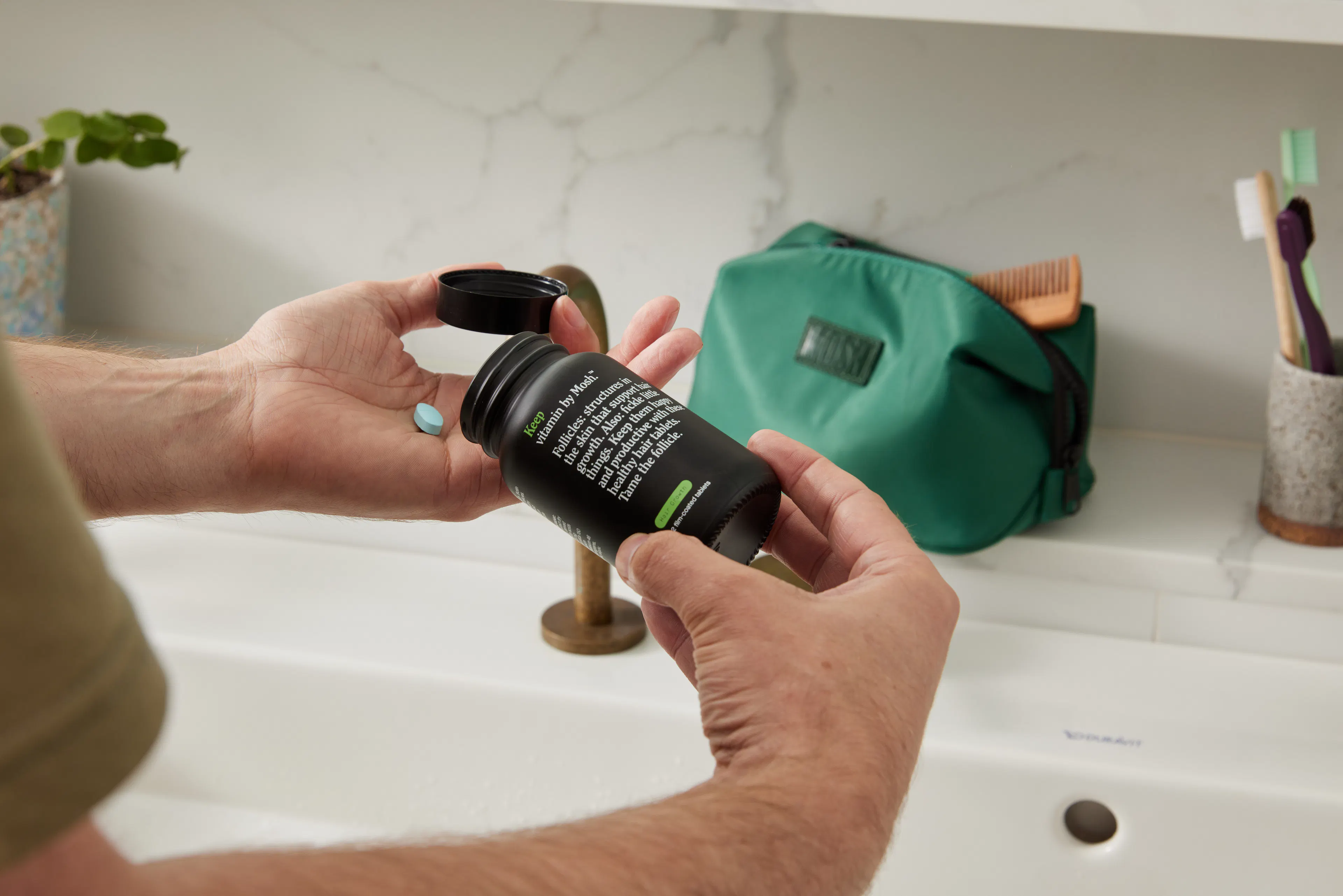 Man taking his hair regrowth tablet