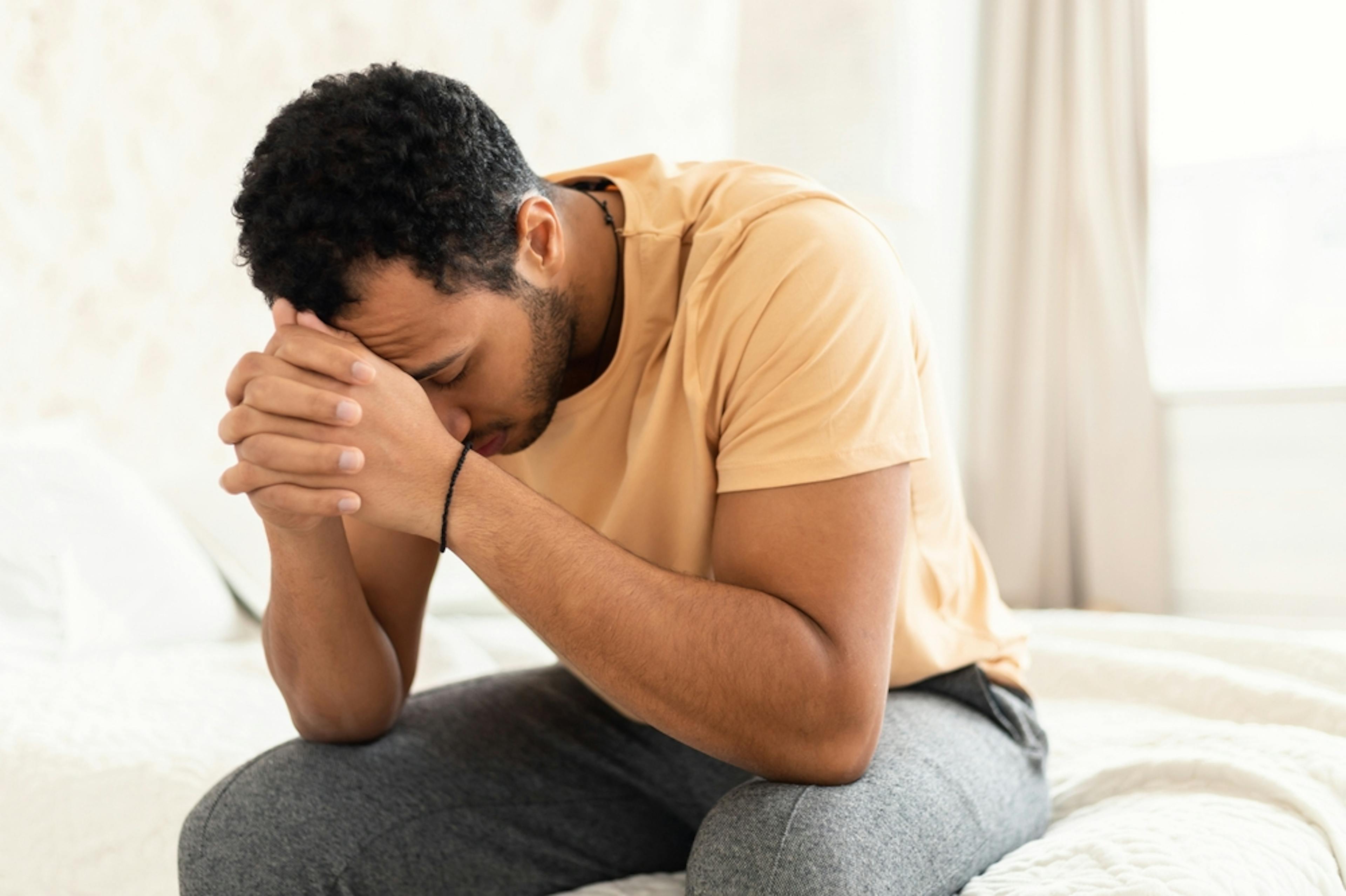 man looking stressed and sitting