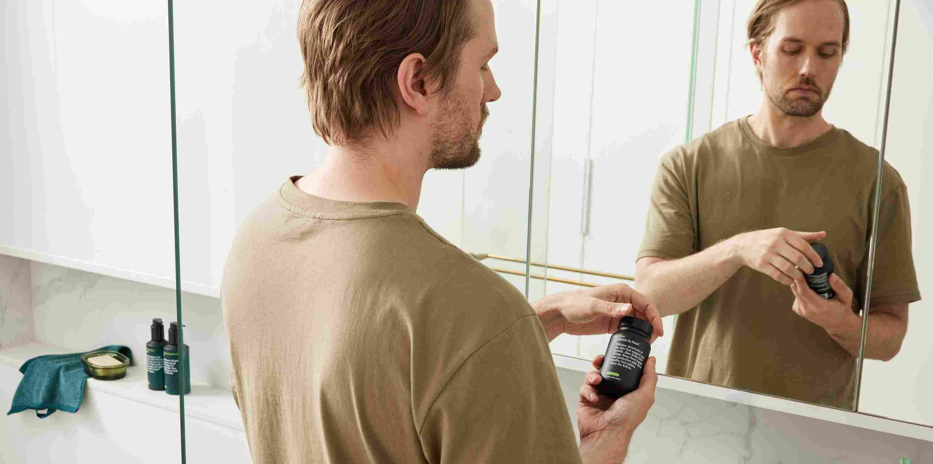 A man reading the bottle of his mosh premature ejaculation prescribed treatment