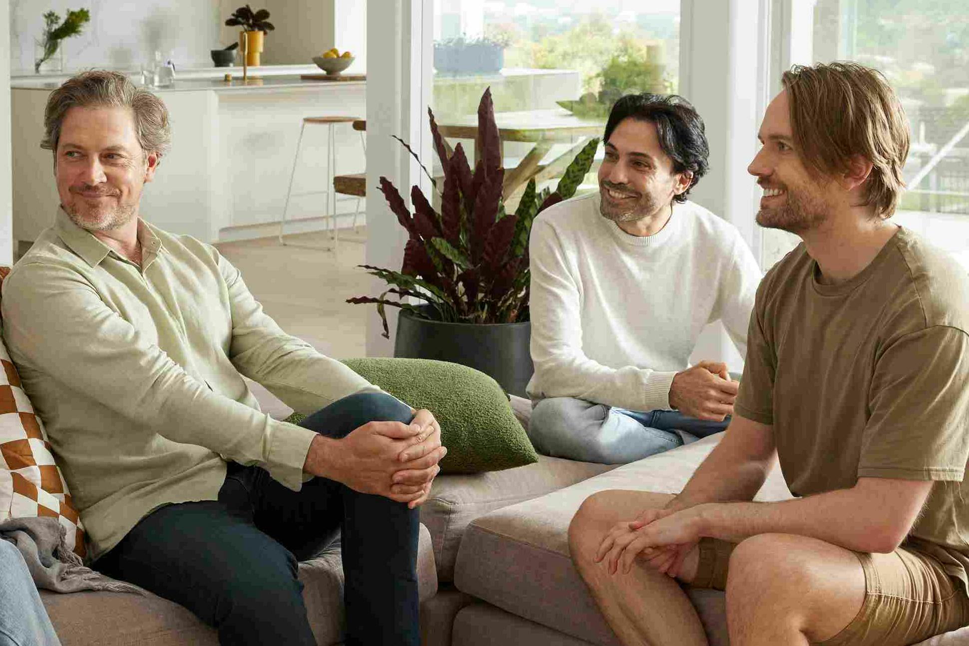 Group of males sitting on the couch smiling