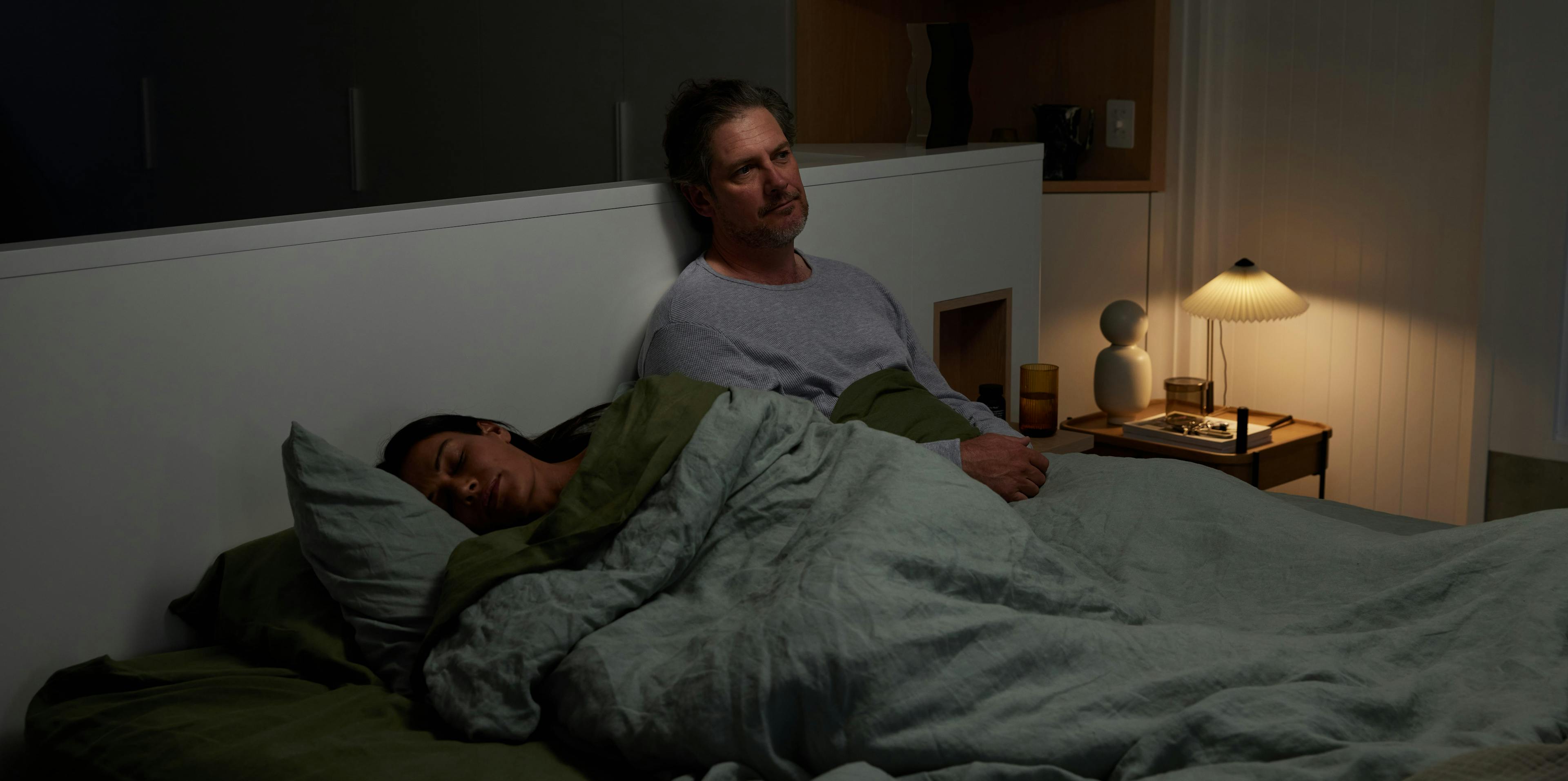 man sad in bed