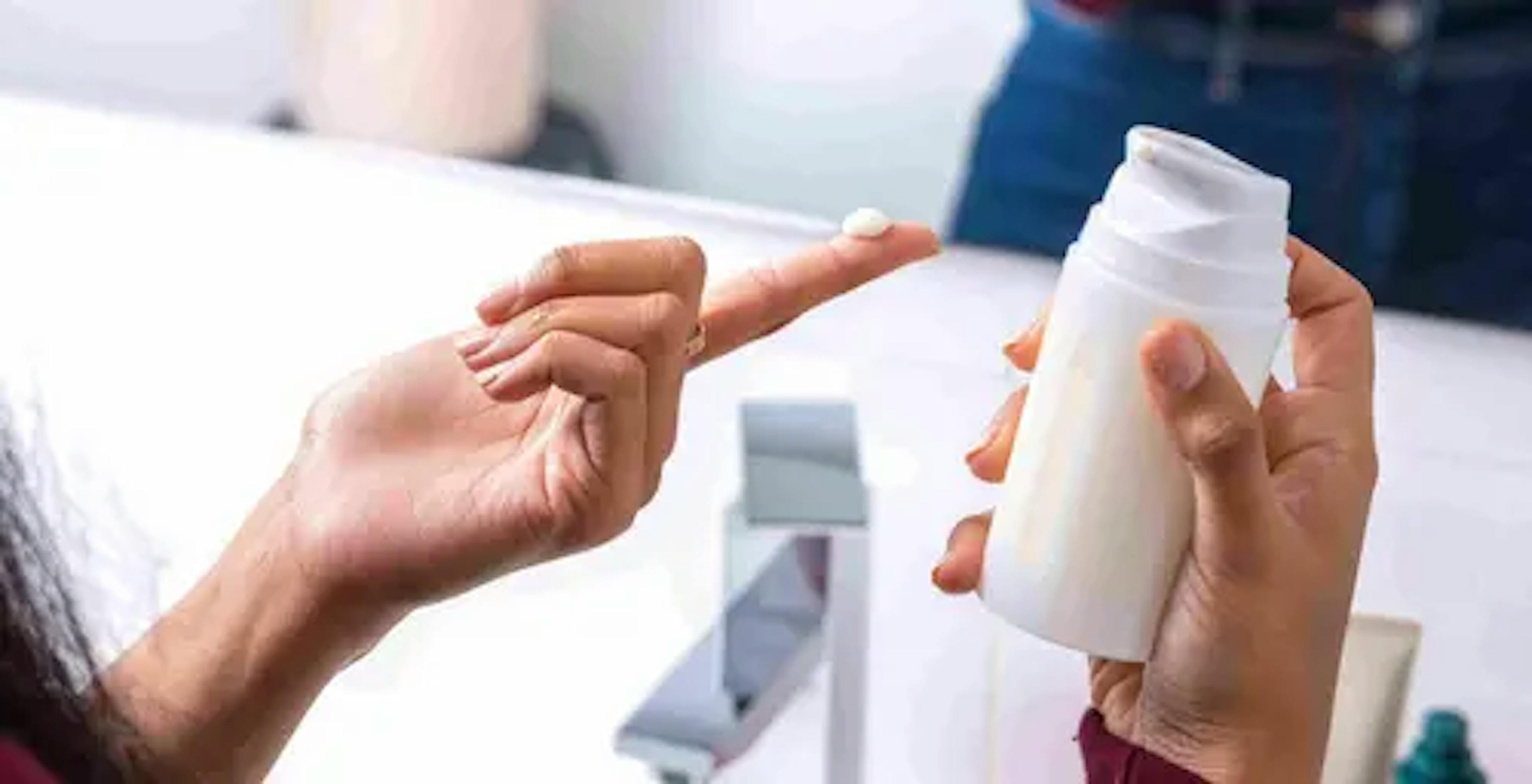 A woman about to apply her acne medication cream 