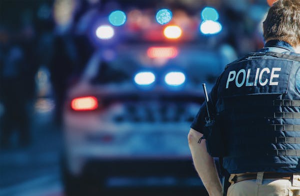Photo of Police Officer and Police Cars.