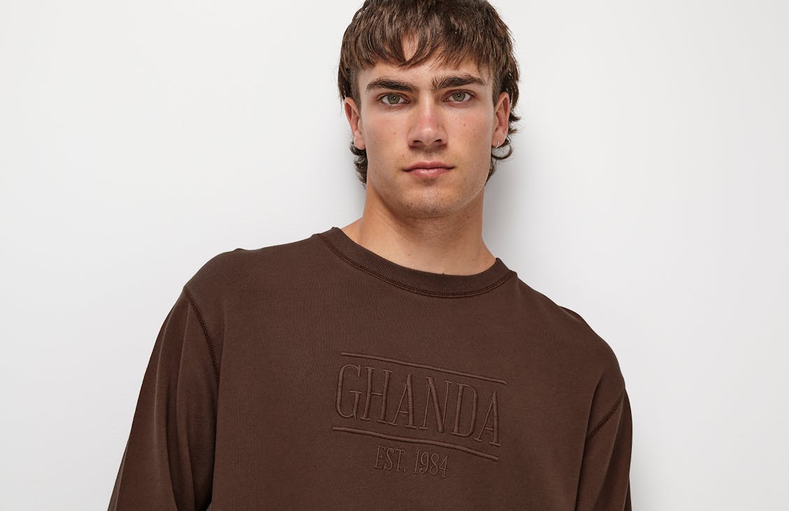 Male model wearing the classic crew in dark earth brown