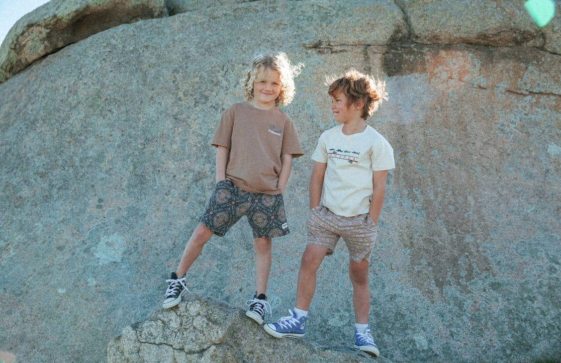 Young male model wearing the Surfy shorts in Kaleidescope with the Surf Tee in Smoke brown.