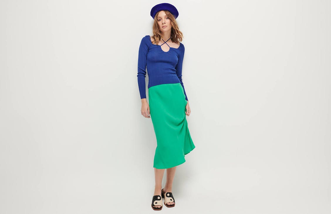 Female model wearing the Storm Slip Skirt in T-Rex Green.