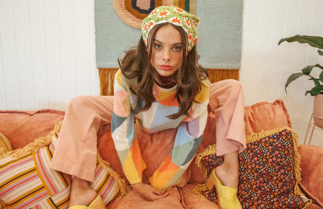 Female model wearing the Lolita knit in 70s bright. 