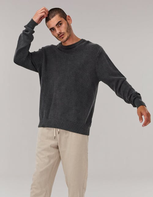 Image of male in studio. He is wearing the Crew Knit and Fala Pants