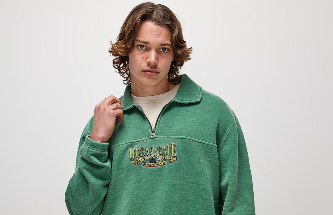Male model wearing the Sorrento Rugby Crew in washed green. 