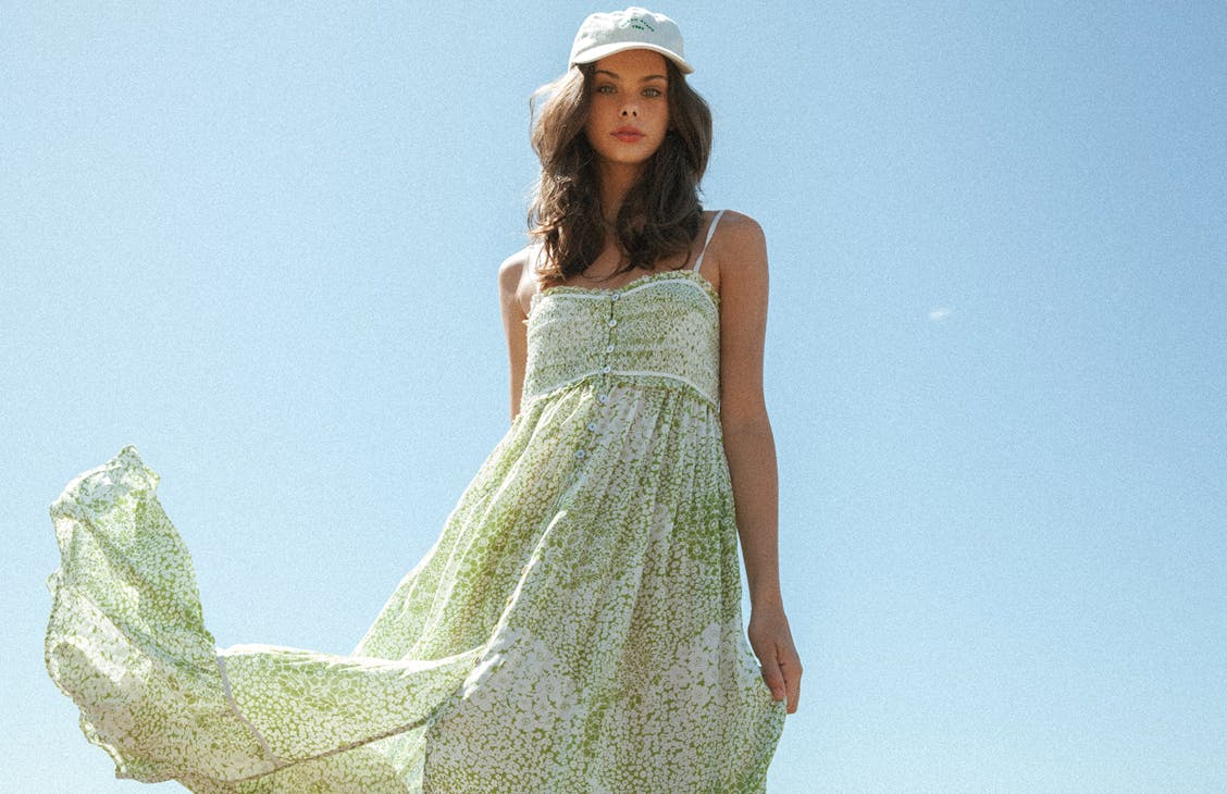 Female model wearing the Charlie Maxi Dress in summer meadow.