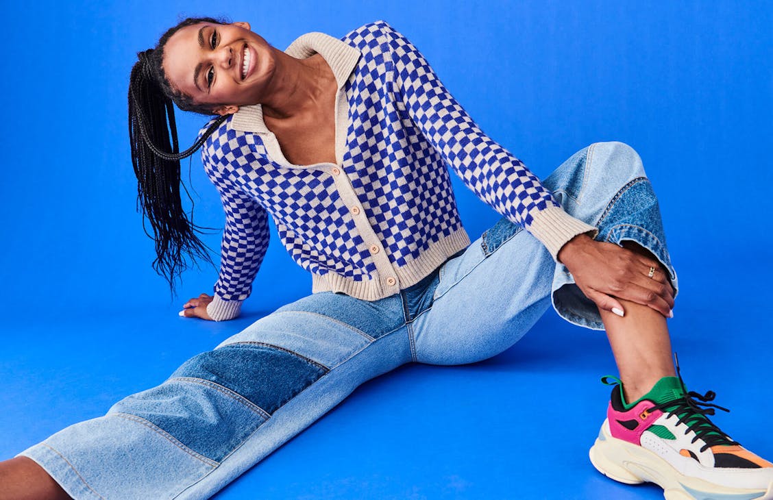 Female model wearing the Cameron jeans in Diagonal Patchwork, sitting on the ground.