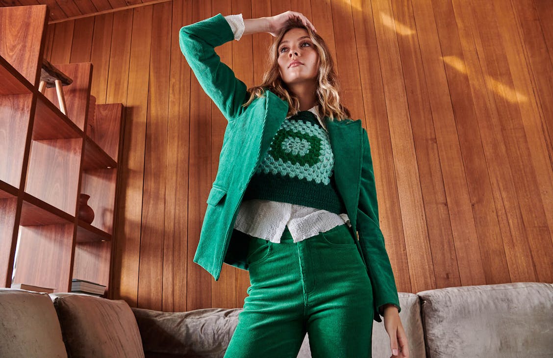 Female model wearing the andie crochet vest in green.