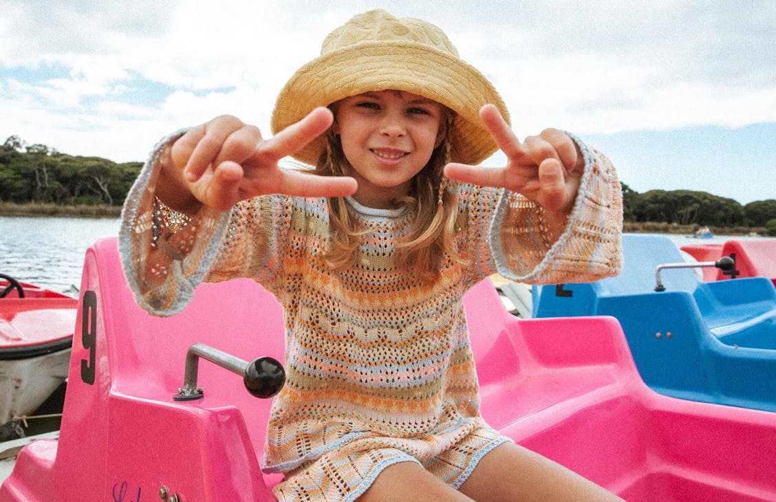 Young female model wearing the Annika knit in dreamer stripe