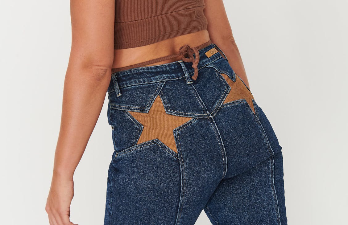 Close up of the back pockets of the Stargazer jeans on a female model.