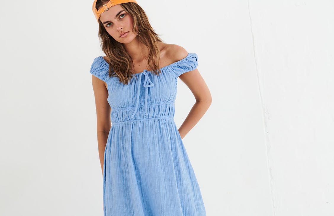 Female model wearing the Peggy Maxi Dress in Sail Blue.